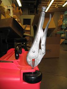 Firmly grip the screw with vise-grip pliers